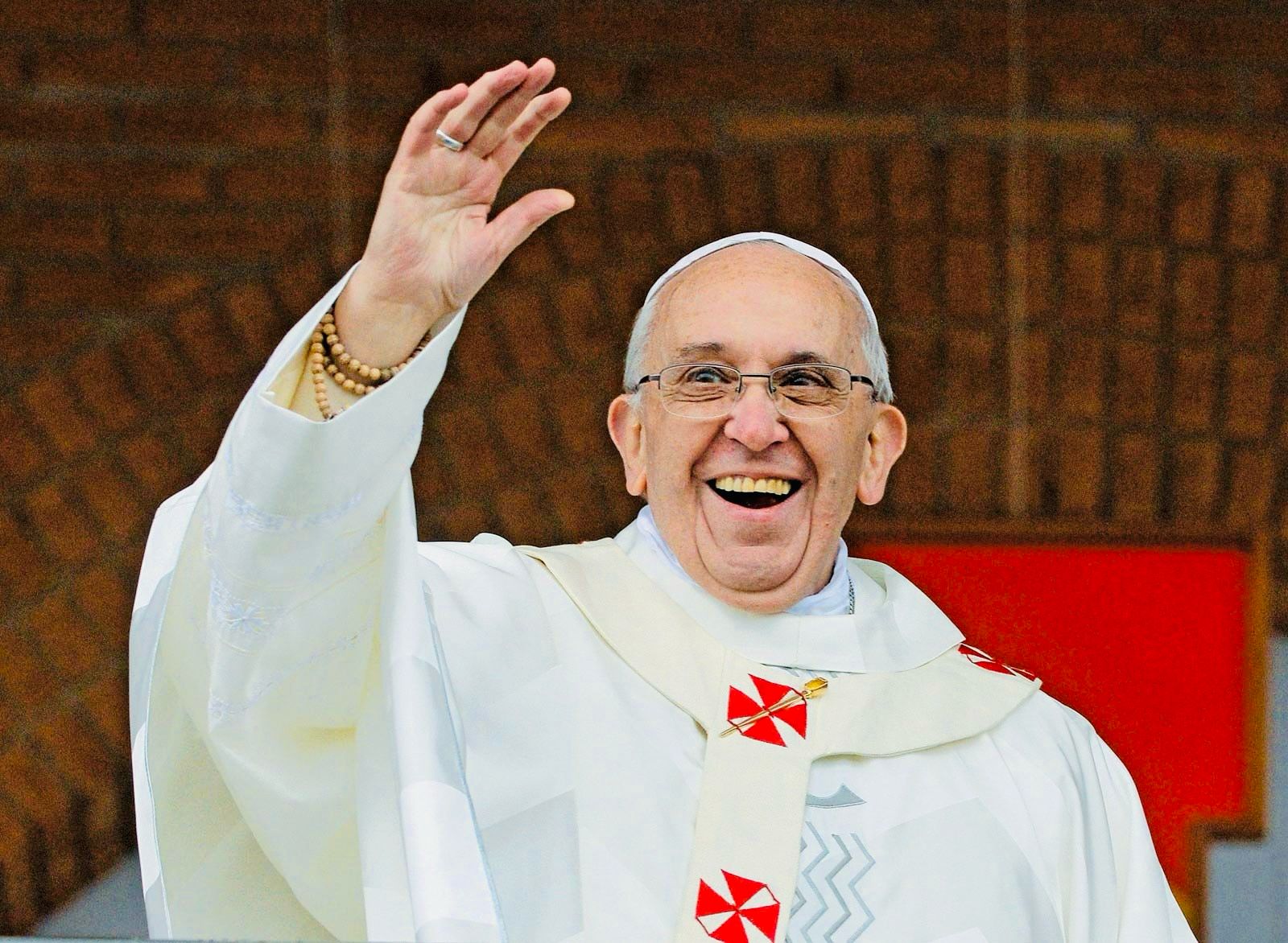 Pope Francis waving outside the church