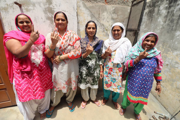 Voter sign India after election on the nail of women portrait at home.